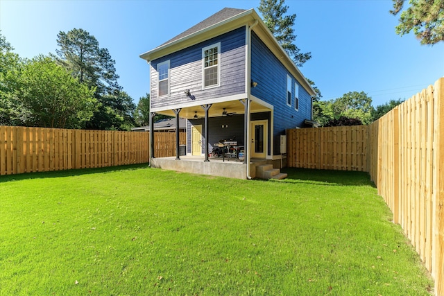 rear view of house featuring a lawn, ceiling fan, and a patio area