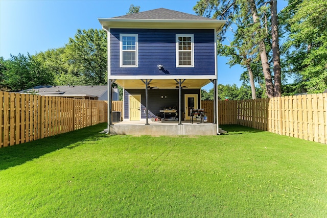 rear view of house featuring ceiling fan, a yard, a patio, and central air condition unit