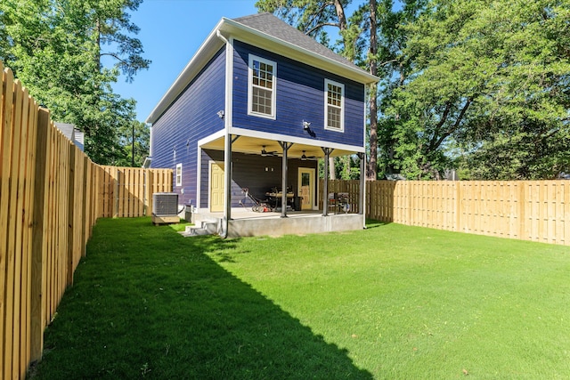 back of house featuring cooling unit, a patio area, ceiling fan, and a lawn