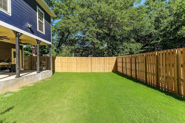 view of yard with ceiling fan and a patio area