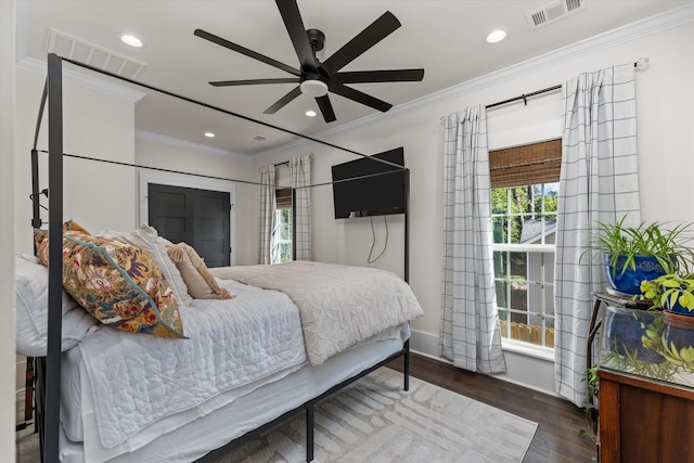 bedroom featuring ornamental molding, dark hardwood / wood-style floors, and ceiling fan