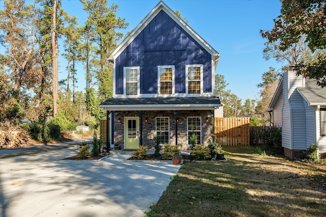 view of front of home featuring a front yard and a porch