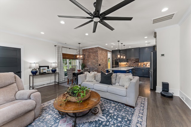 living room with dark hardwood / wood-style flooring, crown molding, and ceiling fan