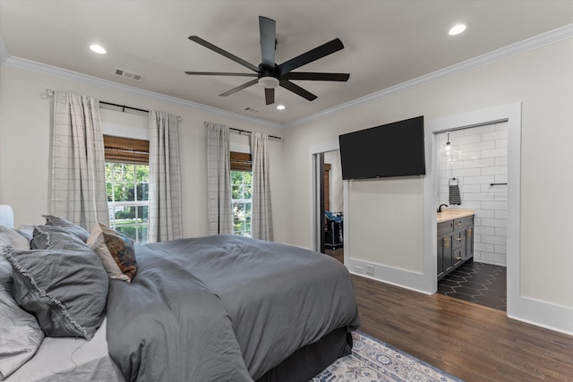 bedroom featuring a walk in closet, ceiling fan, crown molding, dark wood-type flooring, and ensuite bath