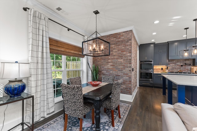 dining area featuring ornamental molding, brick wall, dark hardwood / wood-style floors, and a chandelier