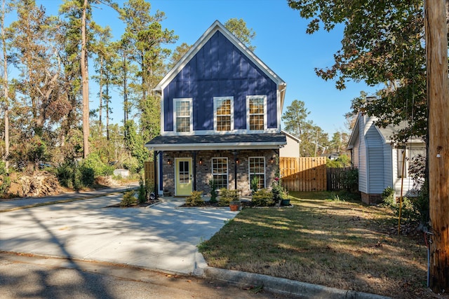 view of front of home with a front yard and a porch