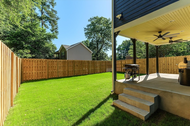 view of yard featuring ceiling fan and a patio area