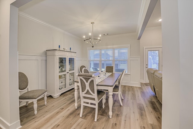 8073 Crossbow Lndg, Graniteville, SC 29829 - dining room with a decorative wall, a chandelier, crown molding, light wood-type flooring, and wainscoting