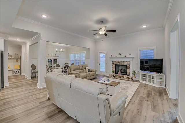 8073 Crossbow Lndg, Graniteville, SC 29829 - living room featuring light wood-style flooring, a ceiling fan, a chandelier, ornamental molding, and baseboards