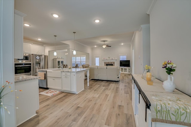 8073 Crossbow Lndg, Graniteville, SC 29829 - kitchen with stainless steel appliances, ceiling fan, white cabinets, open floor plan, and a center island