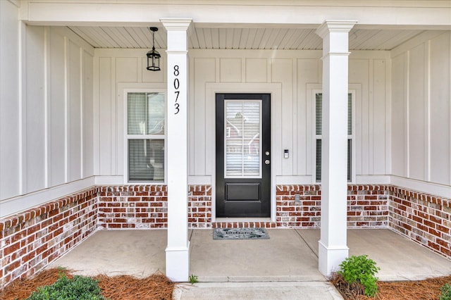 8073 Crossbow Lndg, Graniteville, SC 29829 - doorway to property featuring board and batten siding, a porch, and brick siding