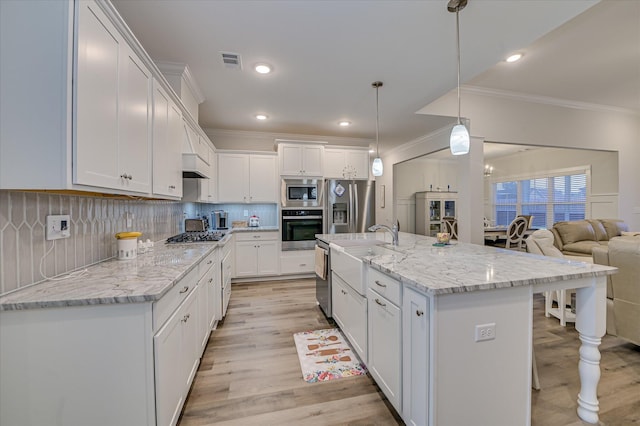 8073 Crossbow Lndg, Graniteville, SC 29829 - kitchen featuring appliances with stainless steel finishes, crown molding, white cabinetry, light wood-type flooring, and backsplash