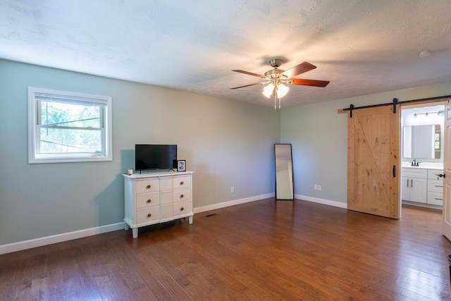 2700 Summit Ridge Rd, Evans, GA 30809 - unfurnished living room with a ceiling fan, hardwood / wood-style floors, and a barn door