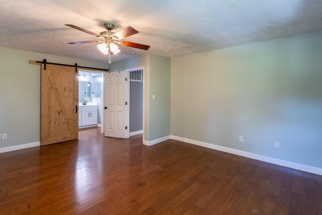 2700 Summit Ridge Rd, Evans, GA 30809 - spare room featuring ceiling fan, a barn door, and dark wood-style floors