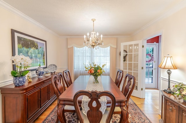 2161 Chadwick Rd, Augusta, GA 30906 - dining room with a chandelier, light wood-style flooring, healthy amount of natural light, and crown molding
