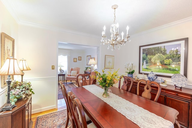 2161 Chadwick Rd, Augusta, GA 30906 - dining area featuring light wood finished floors, crown molding, and a chandelier