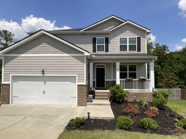 134 Grindle Shls, Grovetown, GA 30813 - craftsman-style home featuring brick siding, covered porch, concrete driveway, and a garage