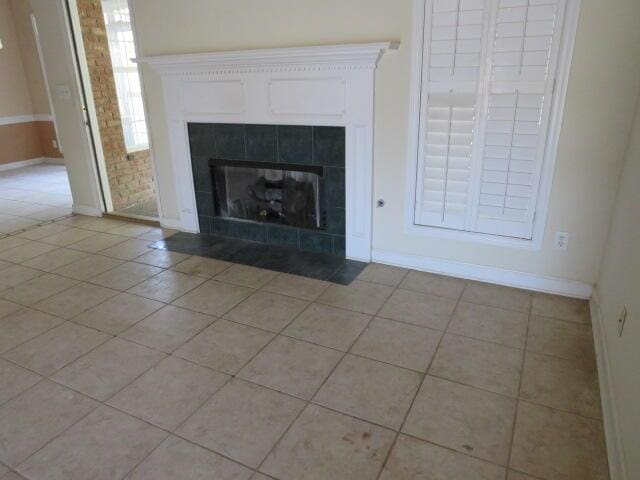 interior details featuring a tile fireplace