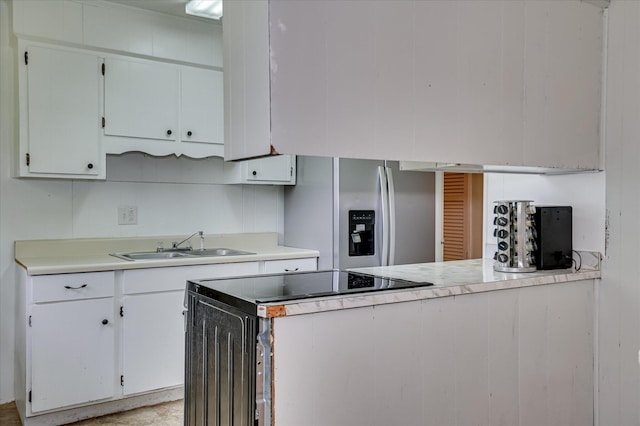 2314 Canberra Ct, Augusta, GA 30906 - kitchen with stainless steel fridge, a sink, light countertops, and white cabinets