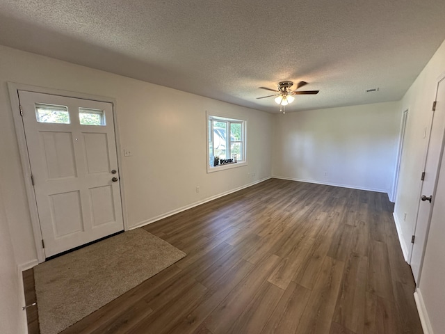 foyer with a textured ceiling, dark hardwood / wood-style floors, and ceiling fan