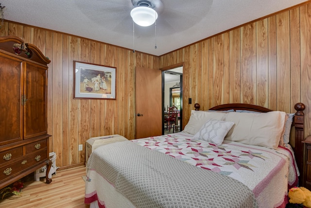 2960 Old Thomson Rd, Appling, GA 30802 - bedroom featuring ornamental molding, ceiling fan, wood finished floors, and wooden walls
