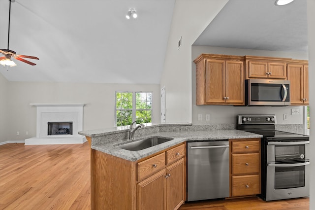 603 Ridgefield Dr, North Augusta, SC 29841 - kitchen featuring appliances with stainless steel finishes, vaulted ceiling, a ceiling fan, light stone counters, and a peninsula
