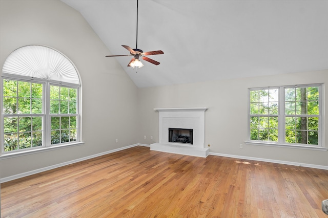 603 Ridgefield Dr, North Augusta, SC 29841 - unfurnished living room with plenty of natural light, a ceiling fan, a fireplace with raised hearth, light wood-style flooring, and high vaulted ceiling