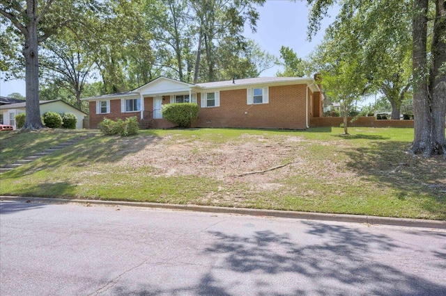 ranch-style home featuring a front yard and brick siding