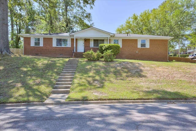 ranch-style house with brick siding, a front lawn, and crawl space