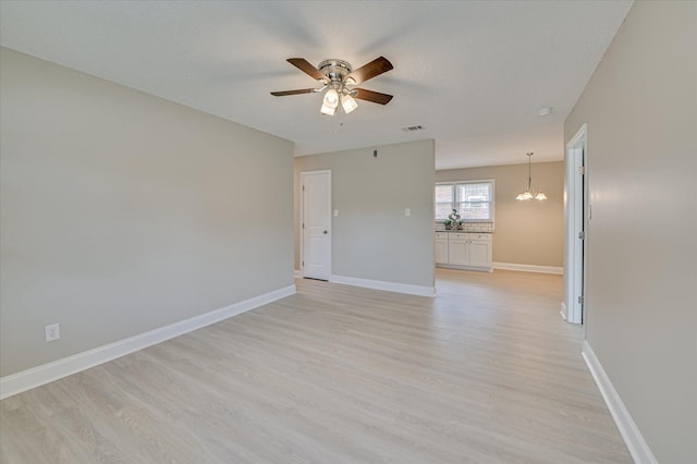 415 Aiken St, Augusta, GA 30901 - unfurnished room featuring light wood-style flooring, a chandelier, a ceiling fan, and baseboards