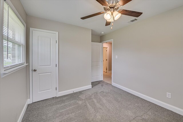 415 Aiken St, Augusta, GA 30901 - unfurnished bedroom with carpet floors, baseboards, and ceiling fan