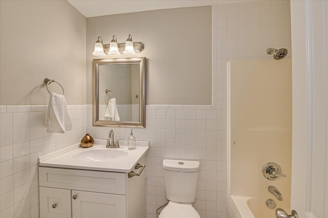 415 Aiken St, Augusta, GA 30901 - bathroom featuring vanity, tile walls, toilet, and bathing tub / shower combination