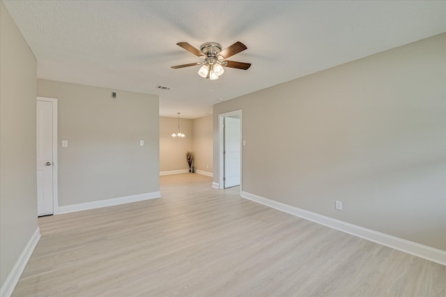 415 Aiken St, Augusta, GA 30901 - unfurnished room with ceiling fan, light wood finished floors, a chandelier, baseboards, and a textured ceiling