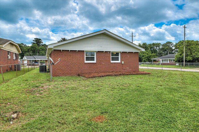 415 Aiken St, Augusta, GA 30901 - view of side of property with brick siding, central AC unit, and concrete driveway
