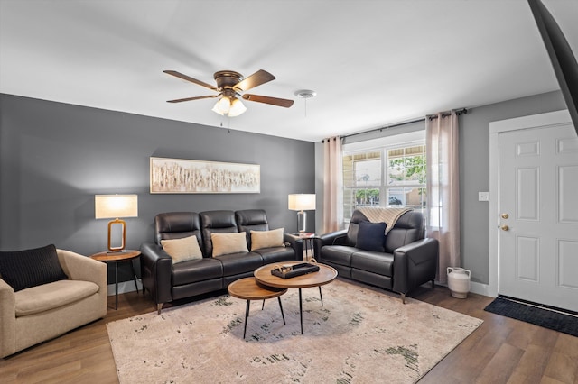 living area with ceiling fan, wood finished floors, and baseboards