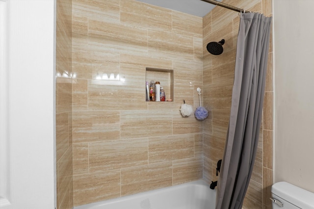 full bathroom featuring shower / tub combo and toilet