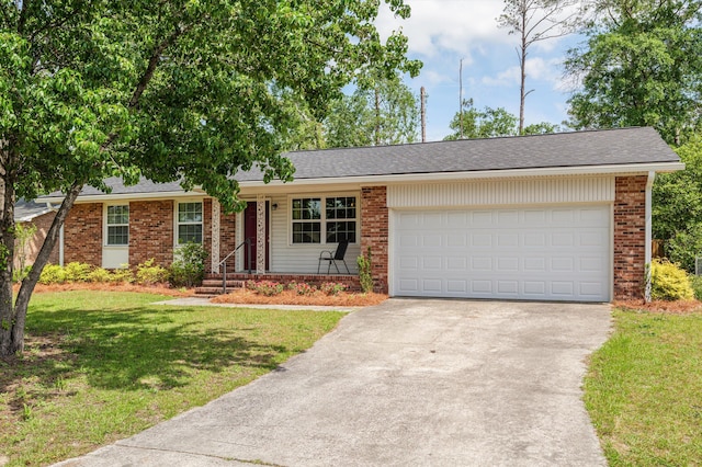 ranch-style home with a front yard, concrete driveway, a garage, and brick siding