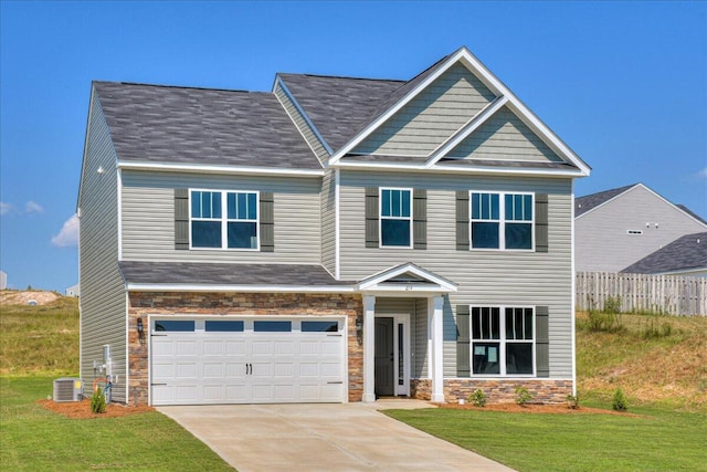 craftsman inspired home featuring central AC, a garage, and a front lawn