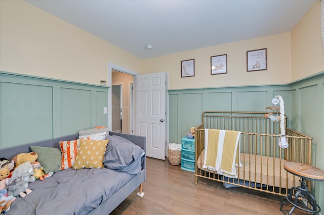 1745 Oak Dr, Augusta, GA 30904 - bedroom featuring a decorative wall, wood finished floors, and a wainscoted wall