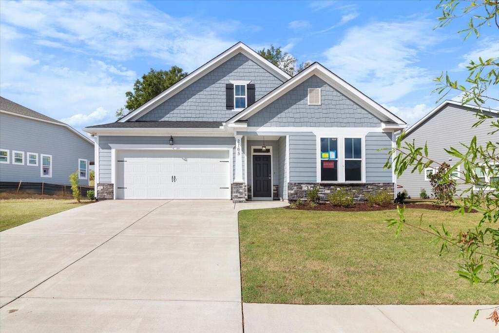 craftsman-style home with a front yard and a garage