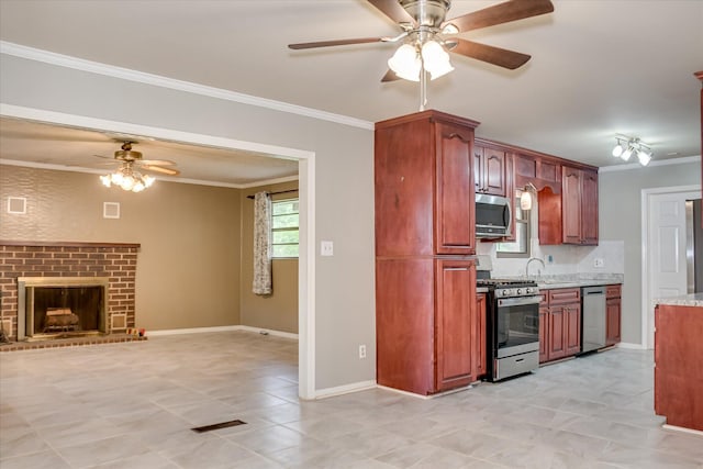 3515 Potomac Dr, Augusta, GA 30906 - kitchen with appliances with stainless steel finishes, a ceiling fan, ornamental molding, open floor plan, and a fireplace