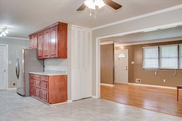 3515 Potomac Dr, Augusta, GA 30906 - kitchen featuring ornamental molding, a ceiling fan, light countertops, freestanding refrigerator, and baseboards