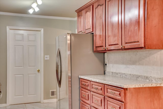 3515 Potomac Dr, Augusta, GA 30906 - kitchen with freestanding refrigerator, tasteful backsplash, light countertops, ornamental molding, and baseboards