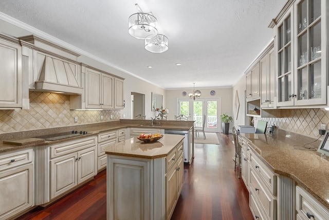 403 Ascot Dr, Aiken, SC 29803 - kitchen with dark wood-style flooring, stainless steel dishwasher, black electric cooktop, a peninsula, and an inviting chandelier