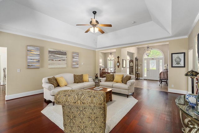 403 Ascot Dr, Aiken, SC 29803 - living room with baseboards, dark wood-style flooring, ceiling fan with notable chandelier, and a tray ceiling