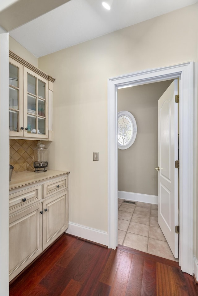 403 Ascot Dr, Aiken, SC 29803 - bar with baseboards, dark wood-style floors, and decorative backsplash