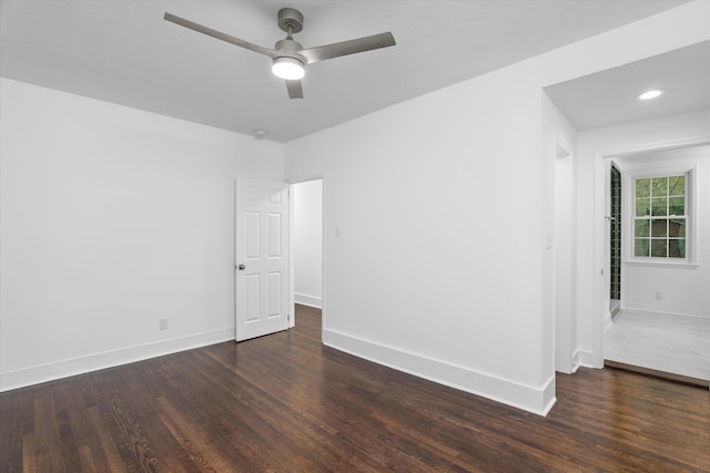 unfurnished room featuring ceiling fan and dark hardwood / wood-style flooring