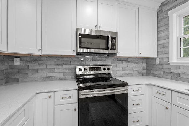 kitchen with stainless steel appliances and white cabinetry