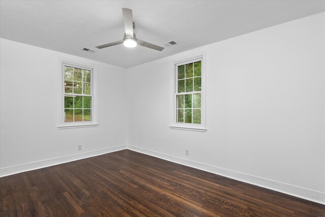 unfurnished room featuring ceiling fan and dark wood-type flooring