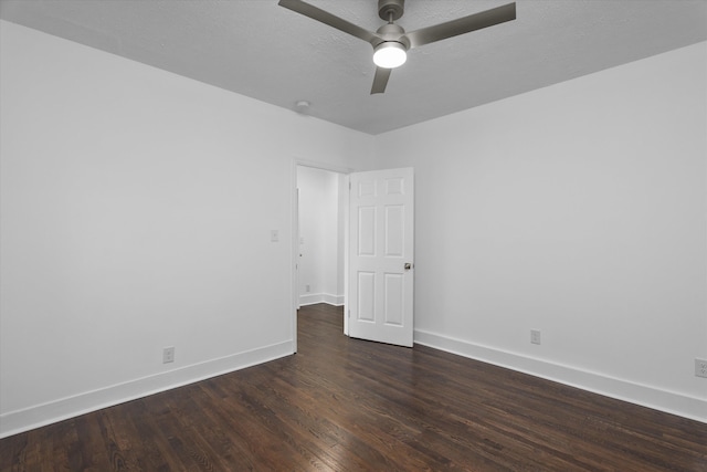 unfurnished room with ceiling fan and dark wood-type flooring